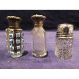 Three early 20th century cut glass Scent Bottles, one with silver top, two with white metal tops,