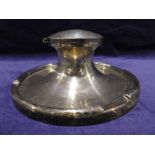 A large early 20th century silver Capstan Inkwell, circular form with hinged lid enclosing glass