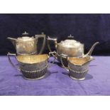 A late 19th century four piece silver Tea Service, oval form, ribbed sides, hinged lids to teapot