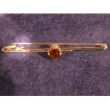 A 9ct gold Bar Brooch set with a single oval smoky quartz stone, 3g gross, 6cm long