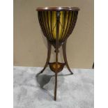 A reproduction Plant Stand on three spayed legs and bentwood slatted sides with brass Lion's masks