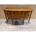 A Regency mahogany and inlaid Dining Room Sideboard of typical form, shaped rectangular top above