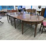 A Regency mahogany and line inlaid D ended extending Dining Table of typical form with square