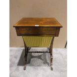 An early 20th century Regency style rosewood Work Table, rectangular top brass lined above a
