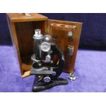A Beck of London 20th century Microscope number 26142, black enamelled, in fitted mahogany case