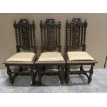 A set of six heavily carved Northern European oak dining chairs with barley twist and turned legs