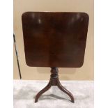 A Regency mahogany flip top Occasional Table, hinged square rounded top on turned central column and