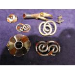 Seven items of Celtic white metal Jewellery Brooches including a circular eight panel flower head