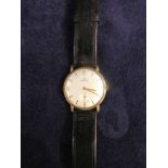 A Gent's Enicar 9ct gold, 17 Jewel Wrist Watch with leather strap, 34mm diameter, 29g gross