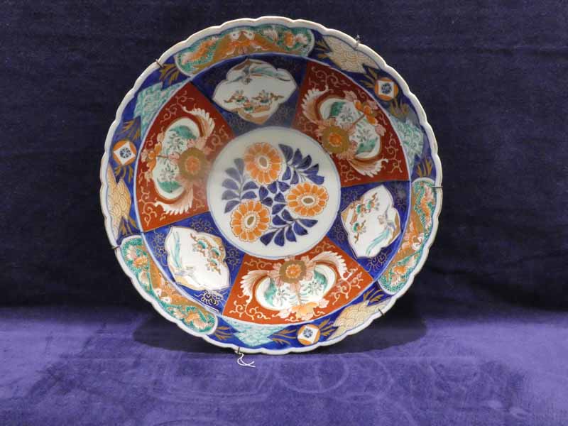 A Japanese 19th century Imari Charger, wavy edge, circular central panel of peonies within a band of