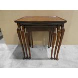 A reproduction mahogany Nest of three Occasional Tables, rectangular tops with raised moulded