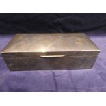 An early 20th century silver cased Cigarette Box, rectangular with hinged dome top lid wood