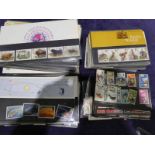 A box of first day covers and loose GB stamps