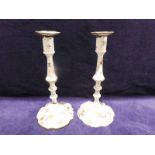 A pair of 18th century Staffordshire enamel Candlesticks, polychrome decorated with flower sprays on