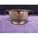 An Edwardian silver two-handled Porringer, circular with reeded rim on stepped circular foot with