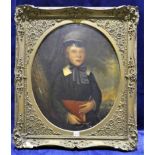 A Victorian oil on canvas portrait of a young boy holding a book, oval panel in a square gilt frame,