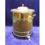 A cylindrical brass coal bin with two T shaped handles, 27cm diameter by 40cm