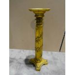 A carved gilt wood plant stand with quatrefoil base and scrolling vine around the column, 102cm high