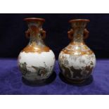 A pair of early 20th century Japanese two-handled Vases, globular with tall neck, typically