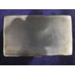 A mid 20th century silver Cigarette Case, rectangular with engine turned exterior surfaces,