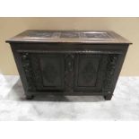 A Continental two-panel carved oak Blanket Chest Front with figural supports and lozenge carved