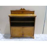 An Edwardian oak bookcase, swan neck pediment on shallow panel back, moulded edge rectangular top