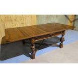 A large oak draw leaf Table on cup and cover baluster legs with diagonal stretchers 137cm (244 open)