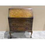 A mid century burr walnut reproduction fall front Bureau, rectangular fall enclosing a fitted