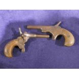 Two small 19th century Pocket or Muff Pistols, single barrel percussion action wooden grips