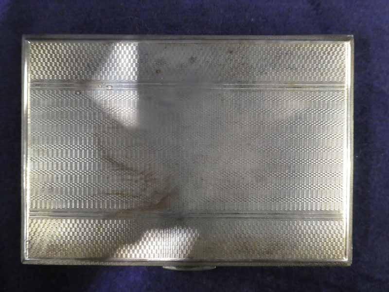 A mid 20th century silver Cigarette Case, rectangular with engine turned surfaces, both internally