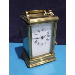 A brass Carriage Clock with French movement, with a key, 8cm by 6.5cm by 13cm, side glass cracked,