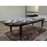 A large Victorian style mahogany extending dining table, moulded D ended rectangular top extends