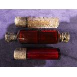 A late Victorian ruby glass Double Scent bottle, facetted body with white metal mounts, one