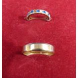 A 9ct gold Wedding Band, size Z and a yellow metal Eternity Ring set with white and blue stones,