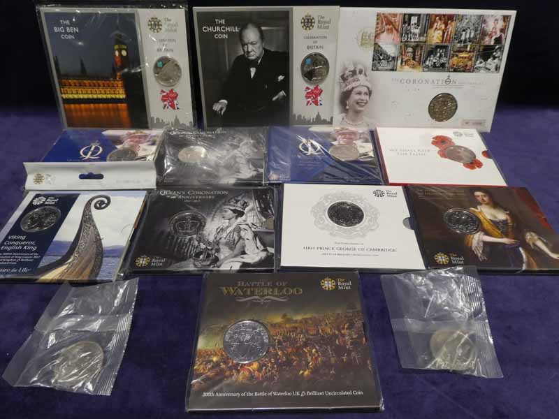 Fourteen uncirculated commemorative £5 coins