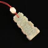 A WARRING STATES PERIOD (475-221 BC) STYLE CELADON JADE PENDANT, CHINESE, each surface carved with a