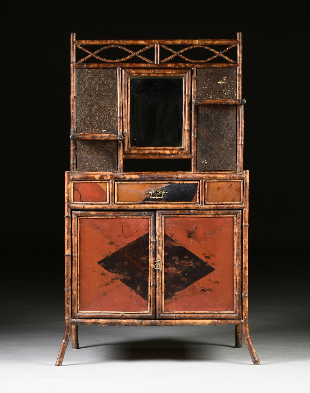 A VICTORIAN LACQUERED AND CARVED BAMBOO DRESSING STAND, CIRCA 1880, in the Japonaiserie taste with a