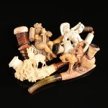 A GROUP OF FOUR MEERSCHAUM PIPES, LATE 19TH/EARLY 20TH CENTURY, carved in the form of a boy flower