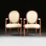 A SET OF FOUR LOUIS XVI STYLE UPHOLSTERED AND CARVED WALNUT FAUTEUILS EN CABRIOLET, 18TH/19TH