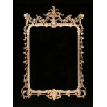 A GEORGE III ROCOCO STYLE PARCEL GILT COMPOSITE MIRROR, MODERN, the crest with a central acanthus