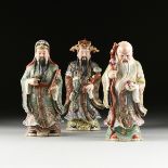 A GROUP OF THREE CHINESE FAMILLE ROSE PARCEL GILT PORCELAIN FIGURES OF THE THREE IMMORTALS, EARLY