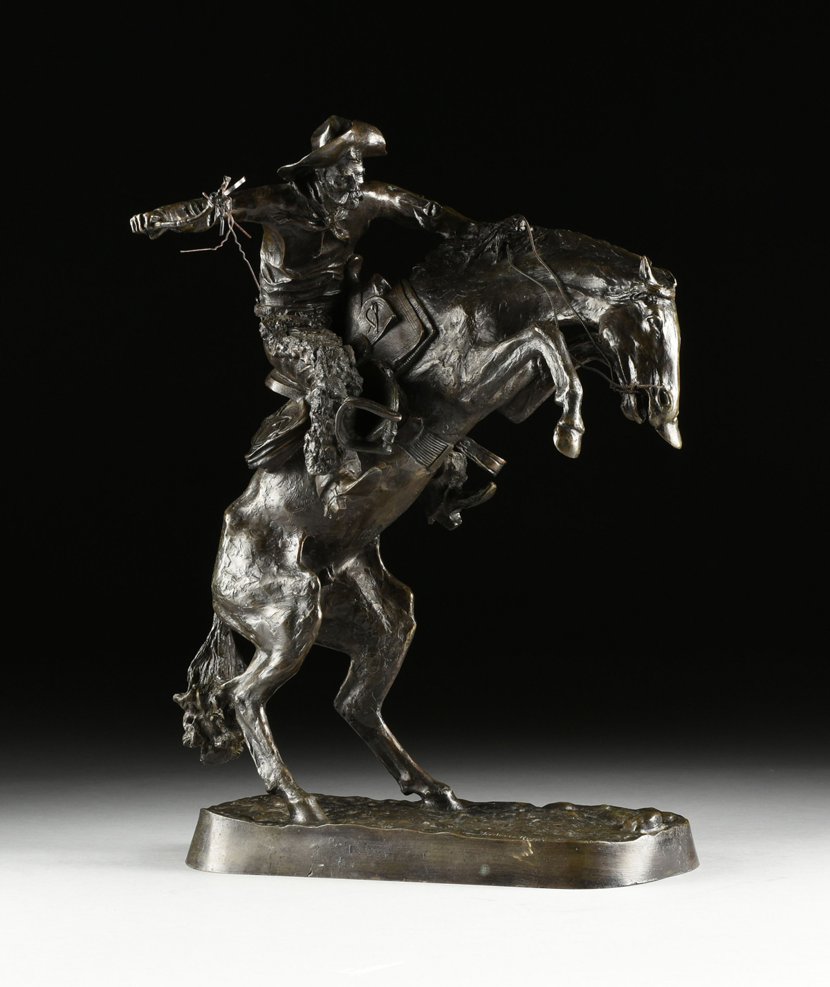 FREDERIC REMINGTON (American 1861-1909) A BRONZE SCULPTURE, "Bronco Buster," with dark brown - Image 8 of 16
