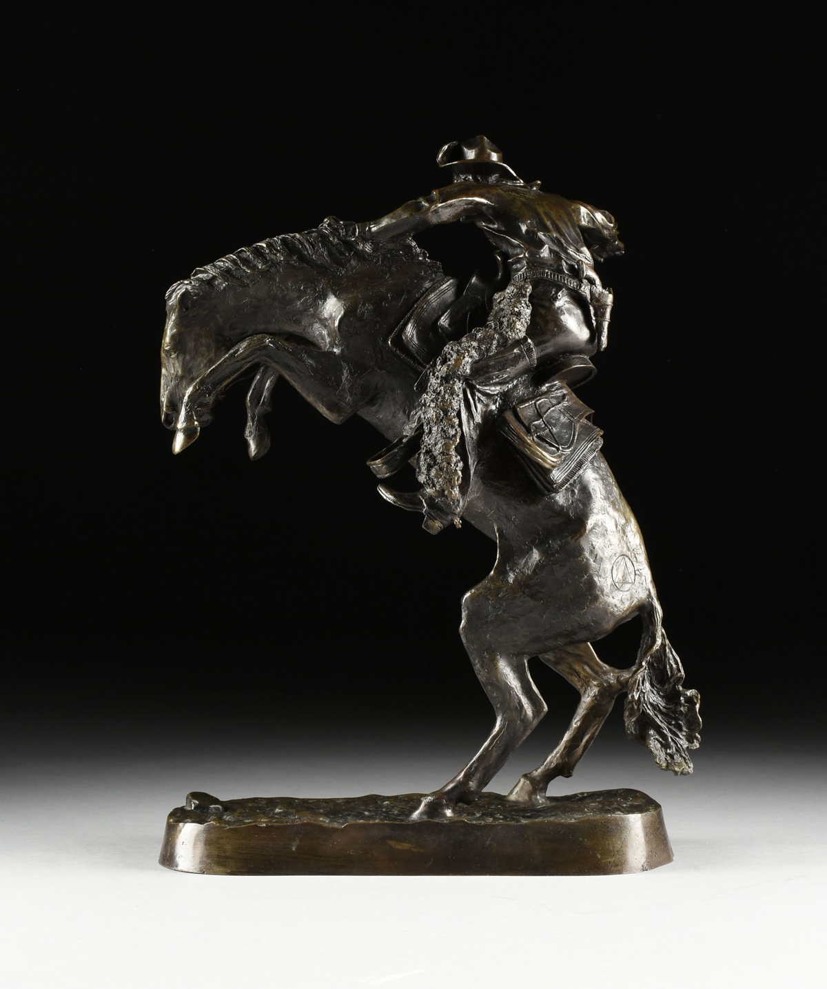 FREDERIC REMINGTON (American 1861-1909) A BRONZE SCULPTURE, "Bronco Buster," with dark brown - Image 10 of 16