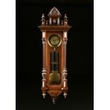 AN ANTIQUE BRASS AND CARVED WALNUT REGULATOR WALL CLOCK, POSSIBLY AUSTRIAN, LATE 19TH CENTURY, the