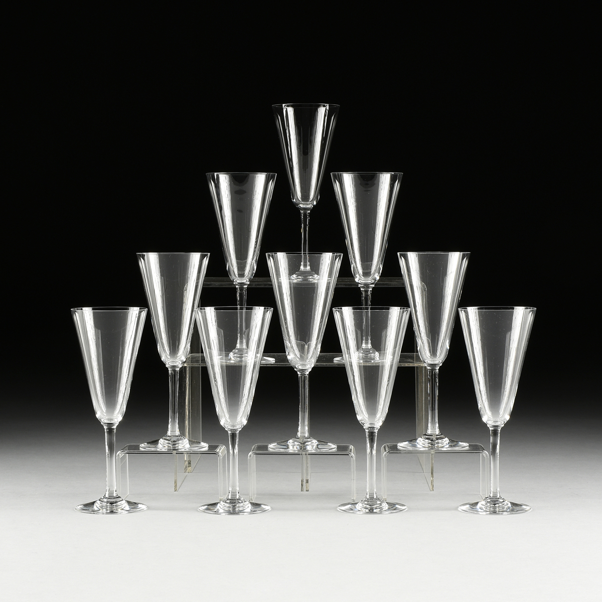 A SET OF TEN BACCARAT CRYSTAL CHAMPAGNE FLUTES, PATTERN 100-192, MODERN, the conical bowl on an