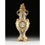 A FRENCH ART NOUVEAU GILT BRONZE MOUNTED FAIENCE VASE CLOCK, CIRCA 1890, the unglazed pale green