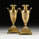 A PAIR OF VICTORIAN TWO HANDLED POLISHED BRASS VASES, 19TH CENTURY, each with a circular leaf tip