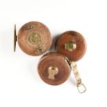 A GROUP OF TWO VINTAGE ENGLISH TAPE MEASURES AND ONE FISHING REEL, EARLY 20TH CENTURY, comprising