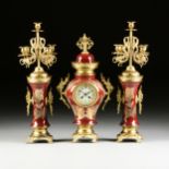 A THREE PIECE CONTINENTAL GILT BRONZE MOUNTED OX BLOOD RED PORCELAIN VASE CLOCK GARNITURE, LATE