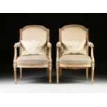 A PAIR OF LOUIS XVI STYLE FORTUNY UPHOLSTERED AND PARCEL GILT CARVED WOOD FAUTEUILS, LATE 19TH/EARLY